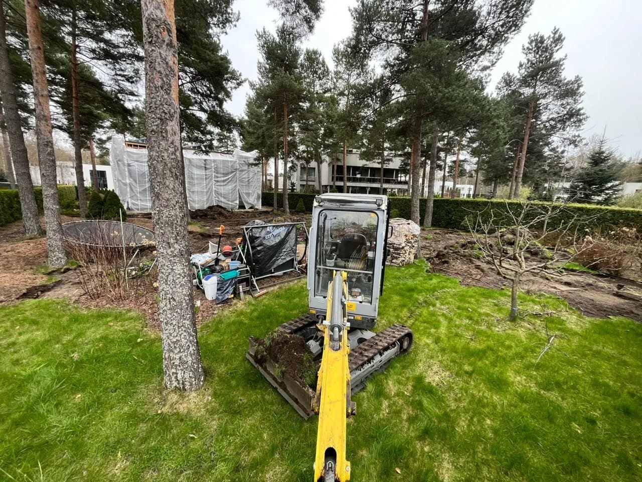 Mini excavator carrying out garden groundworks